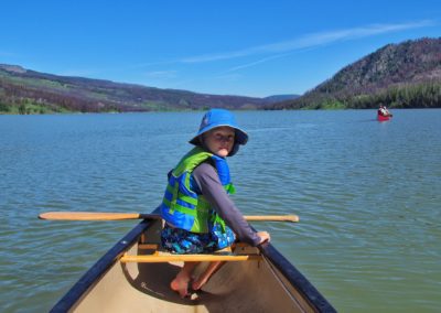 Boy in bow of canoe Jackson Lake Grand Teton National Park